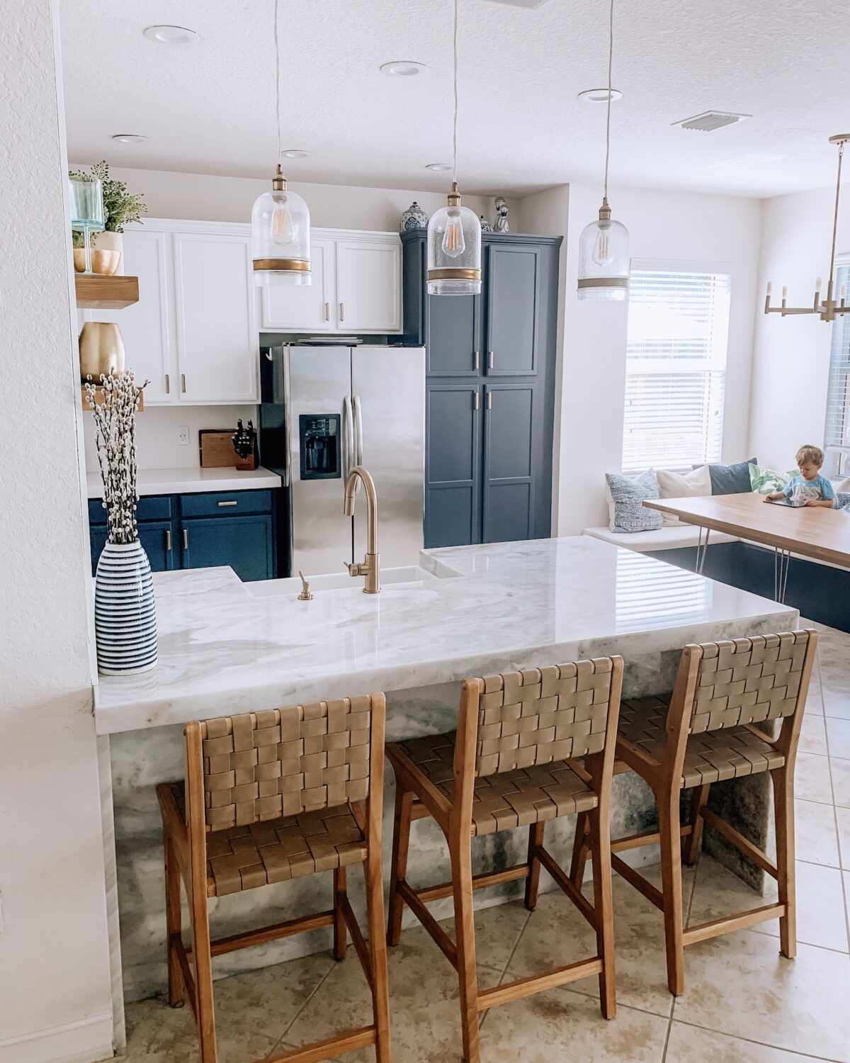 Kitchen before and after, tuxedo cabinets, tan barstools, champagne bronze faucet, blue cabinets, marble island, marble kitchen, Primestones marble Florida